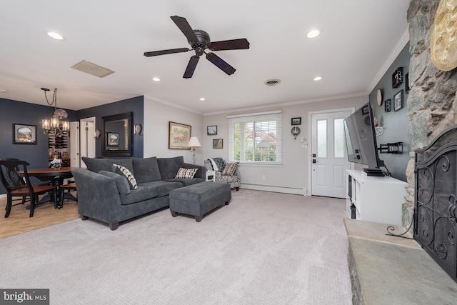 living room with a baseboard radiator, crown molding, ceiling fan with notable chandelier, baseboards, and visible vents