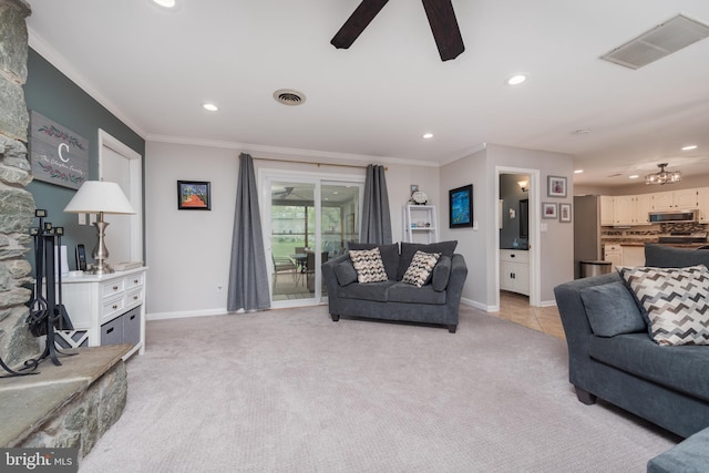 living room featuring baseboards, visible vents, recessed lighting, light colored carpet, and ceiling fan with notable chandelier