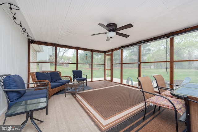 sunroom / solarium with an outdoor living space, ceiling fan, and plenty of natural light