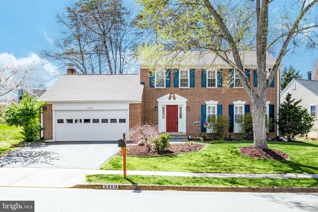 5580 Ann Peake Dr, Fairfax, VA 22032 - colonial inspired home with an attached garage, driveway, brick siding, and a front yard