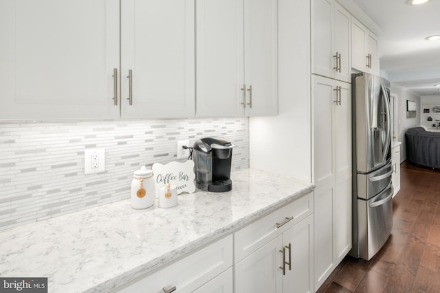 5580 Ann Peake Dr, Fairfax, VA 22032 - kitchen featuring tasteful backsplash, light stone counters, stainless steel fridge, white cabinets, and dark wood-style flooring