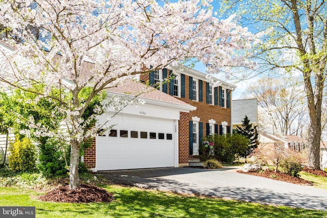 5580 Ann Peake Dr, Fairfax, VA 22032 - view of front of house featuring brick siding, an attached garage, and aphalt driveway
