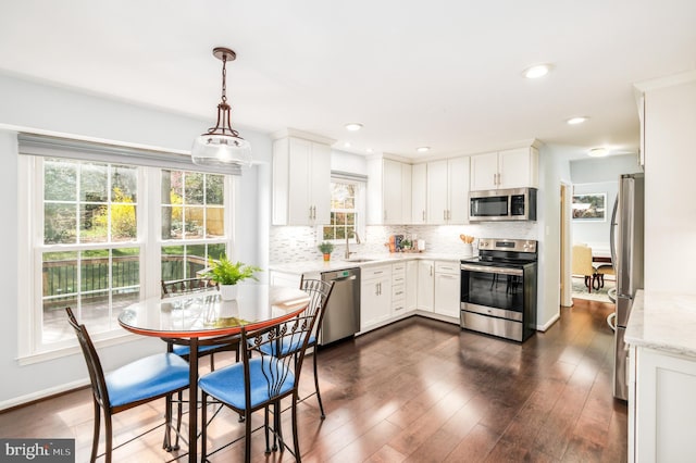 5580 Ann Peake Dr, Fairfax, VA 22032 - kitchen with backsplash, a wealth of natural light, appliances with stainless steel finishes, and a sink
