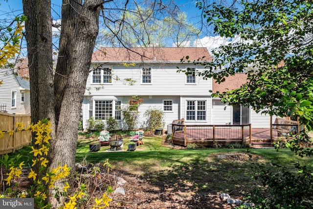 5580 Ann Peake Dr, Fairfax, VA 22032 - rear view of property with fence, a lawn, a fire pit, and a deck