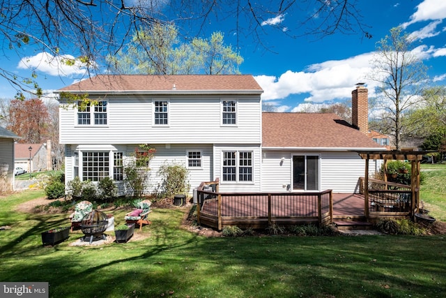 5580 Ann Peake Dr, Fairfax, VA 22032 - back of property featuring a fire pit, a lawn, a wooden deck, and a chimney