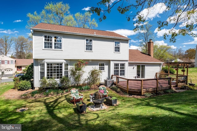 5580 Ann Peake Dr, Fairfax, VA 22032 - back of property with a chimney, a yard, an outdoor fire pit, roof with shingles, and a deck