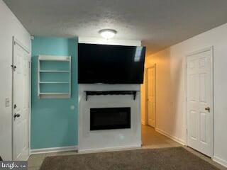 unfurnished living room featuring baseboards and a fireplace