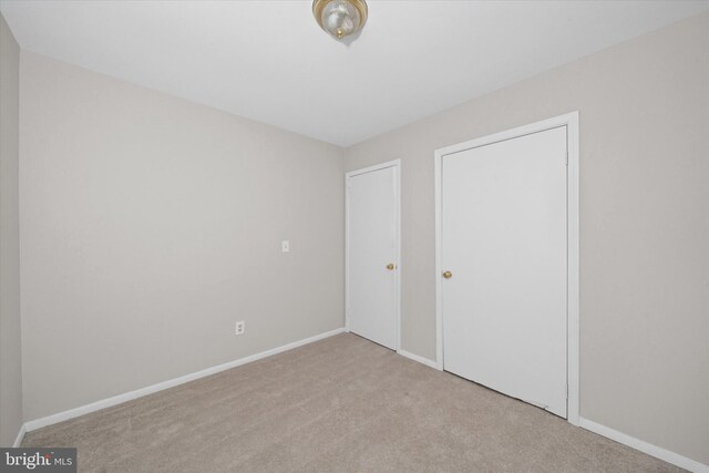 unfurnished bedroom with carpet floors and baseboards