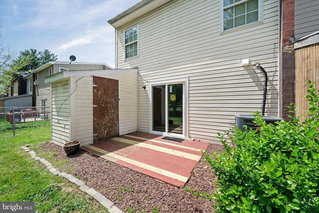 rear view of property with a lawn and fence