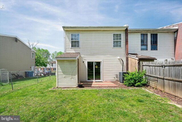 back of property featuring a fenced backyard, central air condition unit, and a yard