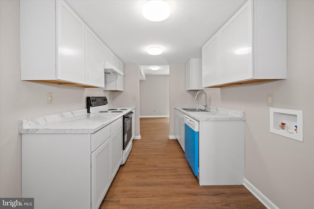 kitchen with white electric range oven, white cabinetry, a sink, and light countertops
