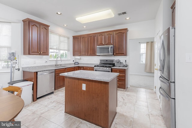 kitchen featuring visible vents, appliances with stainless steel finishes, a center island, a sink, and recessed lighting