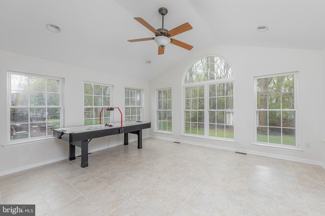 rec room featuring visible vents, lofted ceiling, baseboards, a ceiling fan, and light tile patterned floors