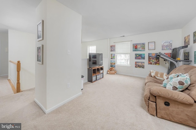 living room with baseboards and light carpet