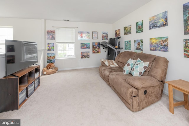 living area with baseboards and carpet