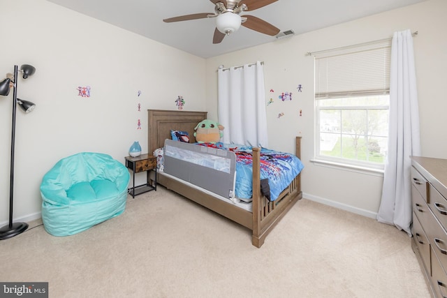 bedroom with baseboards, ceiling fan, light carpet, and visible vents
