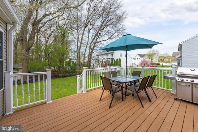 deck with a lawn and outdoor dining space