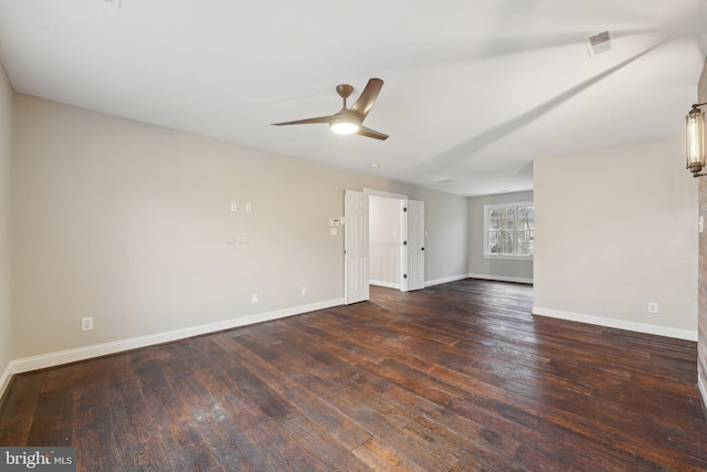 unfurnished room featuring visible vents, a ceiling fan, baseboards, and dark wood finished floors