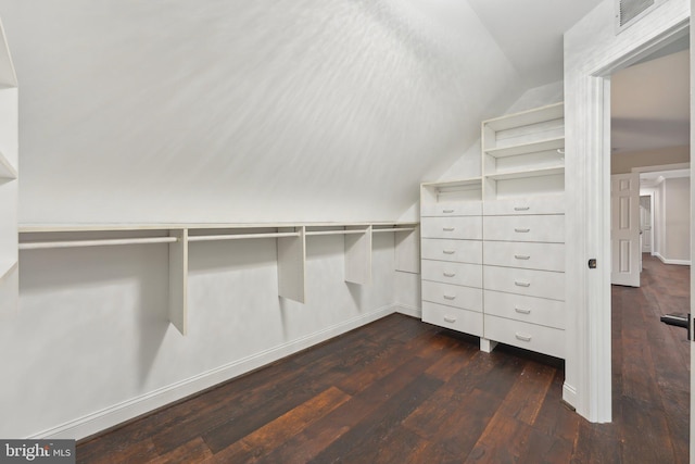 walk in closet featuring lofted ceiling, dark wood-style floors, and visible vents