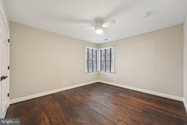 empty room with dark wood-type flooring, baseboards, and ceiling fan