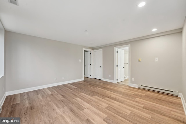 unfurnished room featuring a baseboard radiator, light wood-style floors, baseboards, visible vents, and recessed lighting