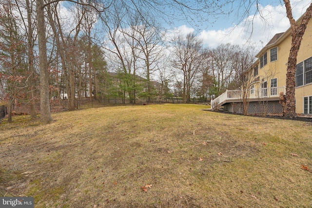 view of yard with fence, stairs, and a deck