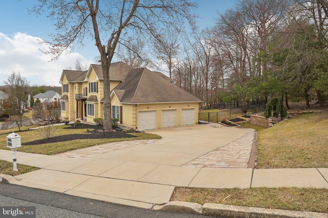 view of front of home with concrete driveway, an attached garage, fence, a front yard, and stucco siding