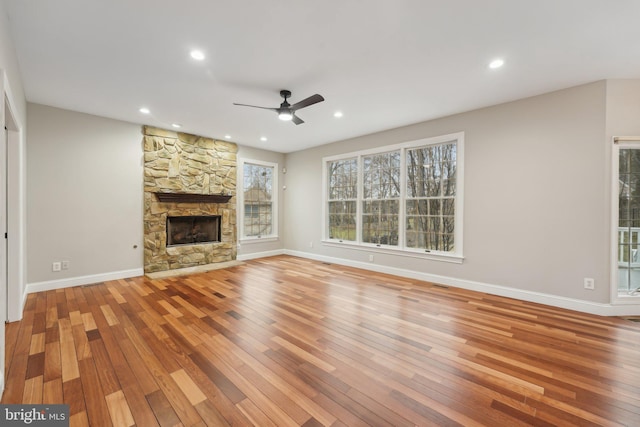 unfurnished living room with ceiling fan, baseboards, light wood-style floors, and recessed lighting