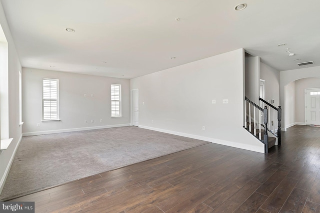 4507 Shakespeare Cir, White Plains, MD 20695 - unfurnished living room with visible vents, baseboards, dark wood-style floors, stairway, and arched walkways