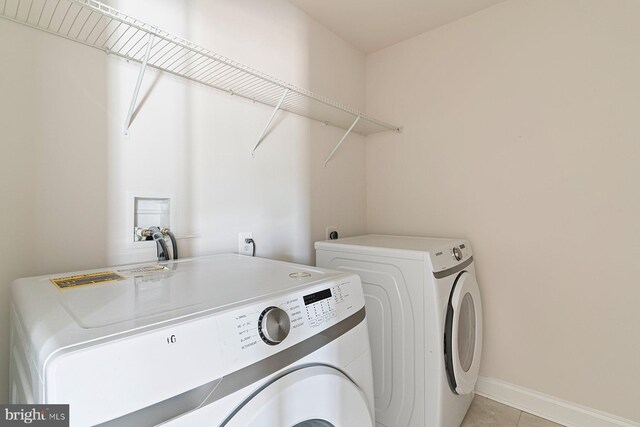 4507 Shakespeare Cir, White Plains, MD 20695 - washroom with baseboards, light tile patterned flooring, laundry area, and washer and clothes dryer