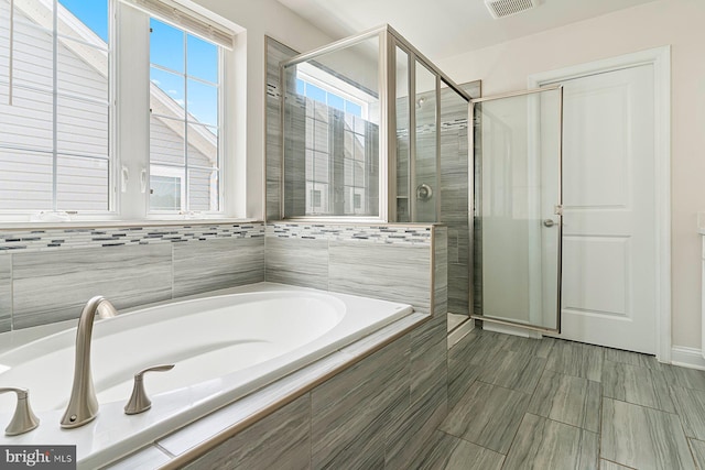 4507 Shakespeare Cir, White Plains, MD 20695 - bathroom featuring a shower stall, a garden tub, and visible vents