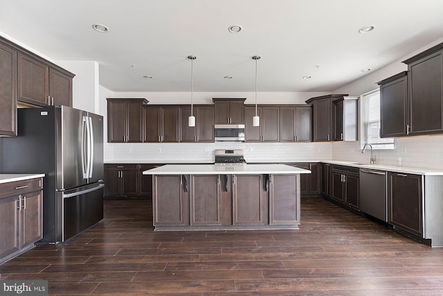 4507 Shakespeare Cir, White Plains, MD 20695 - kitchen featuring a center island, appliances with stainless steel finishes, backsplash, and dark brown cabinets