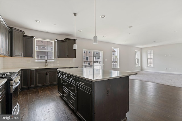 4507 Shakespeare Cir, White Plains, MD 20695 - kitchen featuring a kitchen island, open floor plan, a sink, dark wood finished floors, and gas stove