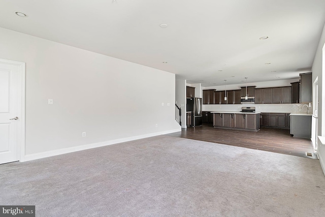 4507 Shakespeare Cir, White Plains, MD 20695 - unfurnished living room featuring dark colored carpet, a sink, and baseboards
