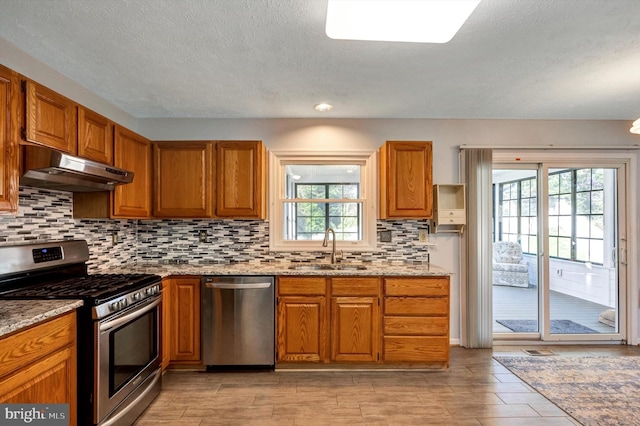 9208 Homestretch Ct, Laurel, MD 20723 - kitchen featuring a sink, appliances with stainless steel finishes, under cabinet range hood, and brown cabinets