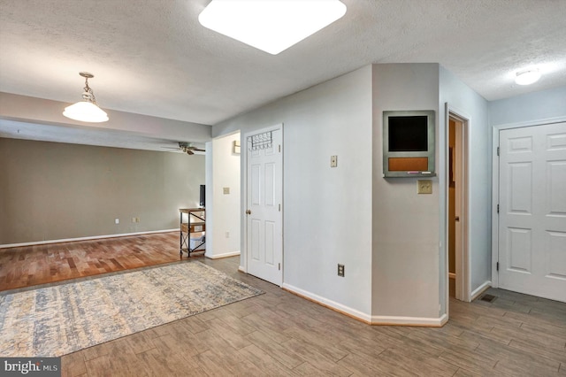 9208 Homestretch Ct, Laurel, MD 20723 - spare room featuring baseboards, a ceiling fan, a textured ceiling, and wood finished floors
