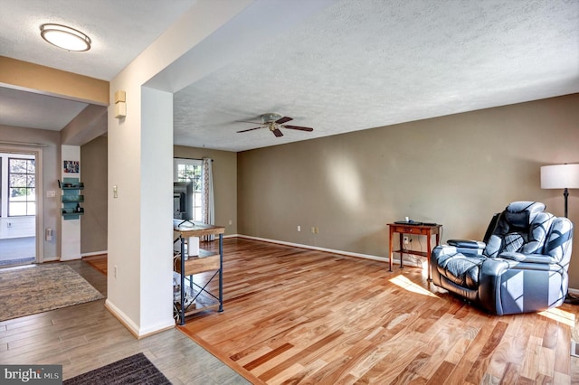 9208 Homestretch Ct, Laurel, MD 20723 - living area with baseboards, a textured ceiling, ceiling fan, and wood finished floors