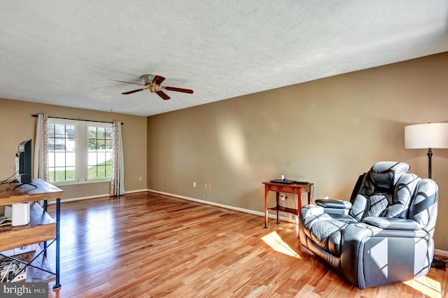 9208 Homestretch Ct, Laurel, MD 20723 - living area with a textured ceiling, ceiling fan, and light wood-style flooring
