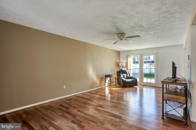 9208 Homestretch Ct, Laurel, MD 20723 - sitting room featuring baseboards, a ceiling fan, a textured ceiling, and wood finished floors