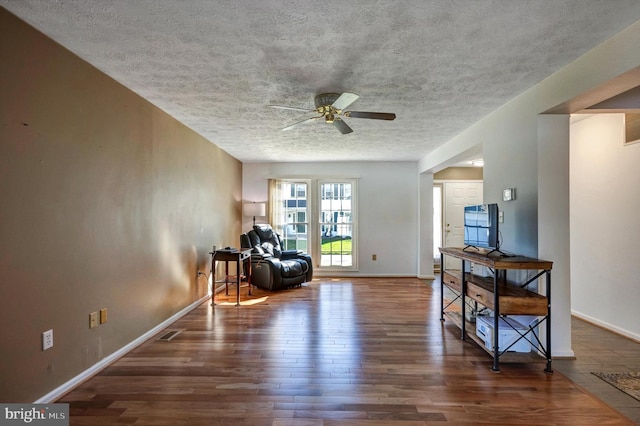 9208 Homestretch Ct, Laurel, MD 20723 - sitting room featuring baseboards, a ceiling fan, a textured ceiling, and wood finished floors