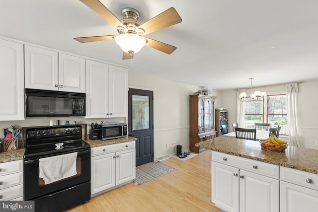 kitchen with white cabinets, visible vents, stone countertops, black appliances, and light wood finished floors