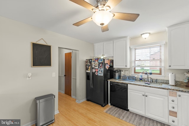 kitchen with fridge with ice dispenser, a sink, light wood-style floors, white cabinetry, and dishwasher