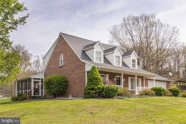 view of side of property with a sunroom, a lawn, and brick siding