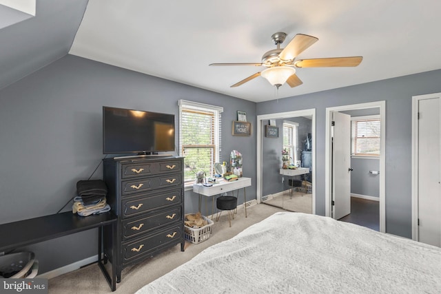 carpeted bedroom featuring ceiling fan, lofted ceiling, and baseboards