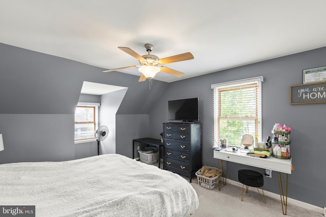 carpeted bedroom featuring multiple windows, ceiling fan, lofted ceiling, and baseboards