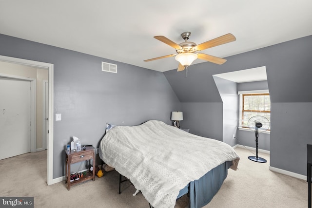 bedroom with visible vents, baseboards, a ceiling fan, and light carpet