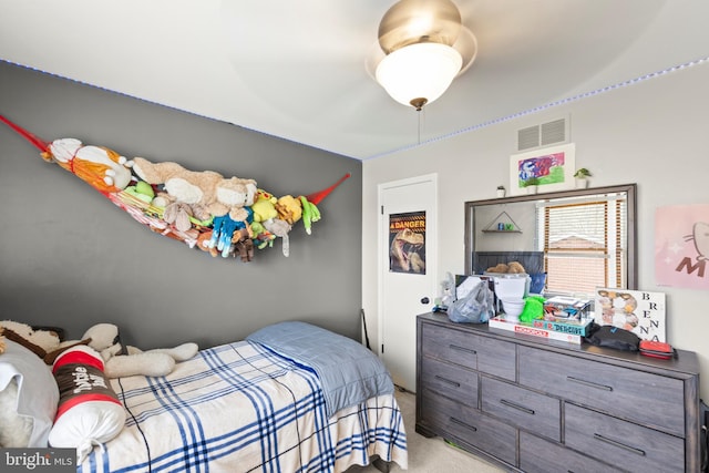 bedroom featuring visible vents and light carpet