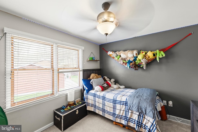 carpeted bedroom with a ceiling fan and baseboards