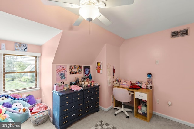 office with lofted ceiling, visible vents, baseboards, light carpet, and a ceiling fan