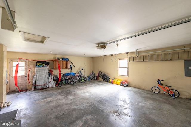 garage with electric panel and a garage door opener